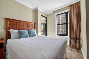 a bedroom with a large bed and two windows at Where the Harbor Wakes For 6 in Destin