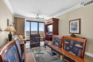 a living room with a couch and a table and chairs at Where the Harbor Wakes For 6 in Destin