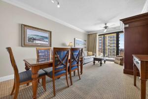 a living room with a desk and chairs in a room at Where the Harbor Wakes For 6 in Destin +77 photos