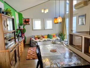 a living room with a couch and a table at Fuji Hike Stay in Oyama