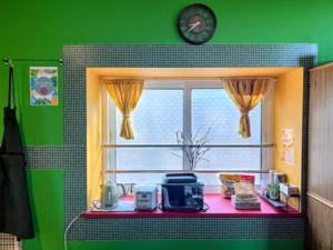 a kitchen with a window and a pink counter top at Fuji Hike Stay in Oyama