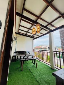 a patio with a picnic table on a balcony at Ambungan Homestay - Siargao in General Luna