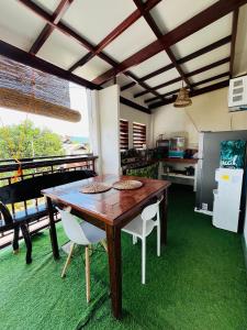 a dining room with a wooden table and chairs at Ambungan Homestay - Siargao in General Luna