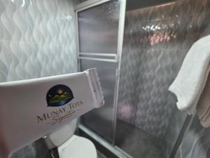a bathroom with a miya tour sticker on the back of a toilet at Munay Tota Signature in Aquitania