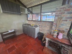 a kitchen with a stove and a brick wall at Munay Tota Signature in Aquitania