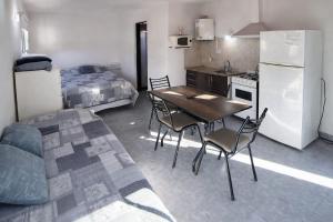a kitchen with a table and chairs and a refrigerator at Gotas de Rocío - Balcón para 4 in San Antonio Oeste