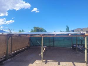 a large metal building with a roof on top at Hospedaje J & L in Uspallata +11 photos