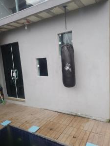 a black punching bag hanging from a wall at Passeio de quadriciclo com hospedagem in Guapimirim