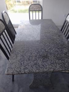 a dining table with two chairs and a table with at Passeio de quadriciclo com hospedagem in Guapimirim