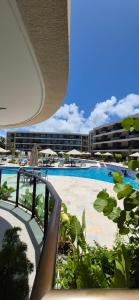 a view of a swimming pool from a resort at Flat Malia Beach 005A in Porto De Galinhas