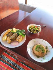 a table with three plates of food on it at Baywatch Camp in Nuweiba