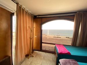 a room with a window with a view of the ocean at Baywatch Camp in Nuweiba