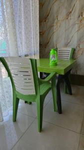 a green table and a chair with a box on it at Amangarh Corbett Farmstay in Rehar +18 photos