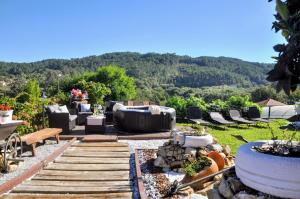 a patio with a couch and chairs in a yard at Casa Santamaria a 5min de Noia cerca de la playa in Lousame +59 photos