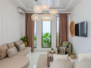 a living room with a couch and a tv at Marram Villas 2 Prime Location in Paje