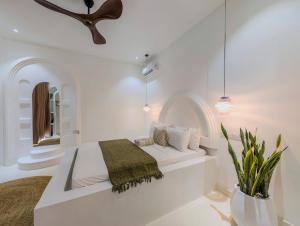 a white bedroom with a bed and a mirror at Marram Villas 2 Prime Location in Paje