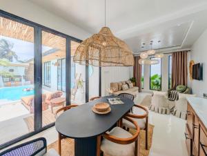 a kitchen and living room with a table and chairs at Marram Villas 2 Prime Location in Paje