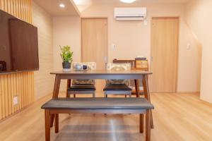 a dining room with a table and chairs at 三十三 和華waka in Kyoto