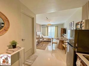 a kitchen and a living room with a refrigerator at Alpine Villas Cozy Staycation in Ulot