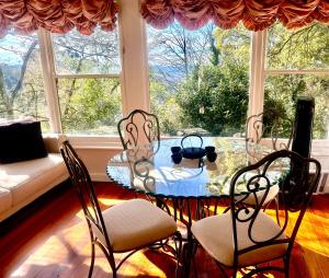 a dining room with a table and chairs in front of a window at Stillwaters in Kalorama
