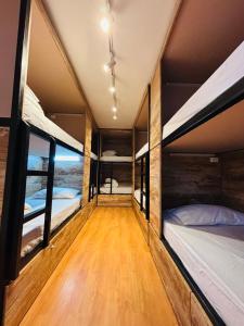 a room with several bunk beds in it at NW Hotel Nomada in Osorno