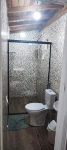 a bathroom with a toilet and a sink at chalé casa na mata céu Iluminado in Guararema