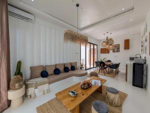 a living room with a couch and a table at Marram Villas 3 Prime Location in Paje