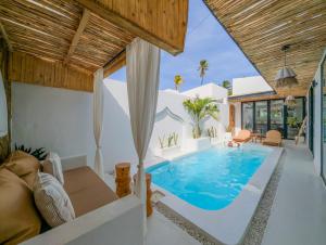 a villa with a swimming pool in a living room at Marram Villas 3 Prime Location in Paje