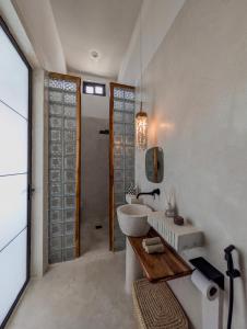 a white bathroom with a sink and a tub at Marram Villas 3 Prime Location in Paje +16 photos
