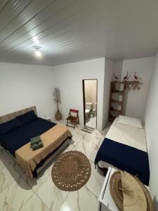 a bedroom with a bed and a mirror in it at Cajuí da Vila Atins in Atins