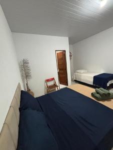 a bedroom with a bed and a chair in it at Cajuí da Vila Atins in Atins +6 photos