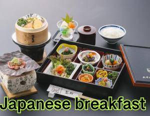 a table with a tray of japanese breakfast foods at Ryokan Asunaro in Takayama