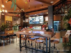 a restaurant with a bar with stools in the middle at Alpine Villas Cozy Staycation in Ulot +18 photos