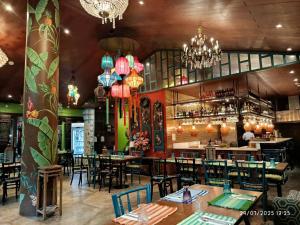 a restaurant with tables and chairs and a bar at Alpine Villas Cozy Staycation in Ulot