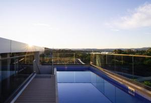 a swimming pool on the roof of a building at Chada by Cadiz Properties - 2 Bedroom Apartment with Lakeview Pool, within CBD and Beside Commonwealth Park in Canberra