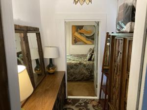 a hallway with a mirror and a bed in a room at The Zoo - This is it! in Saugatuck
