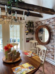 a dining room with a wooden table and chairs at The Zoo - This is it! in Saugatuck