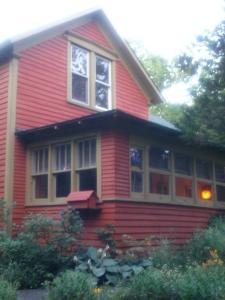 a red house with windows on the side of it at The Zoo - This is it! in Saugatuck