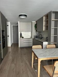 a kitchen with a table and chairs in a room at Las Condes Avenida in Santiago