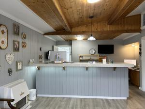a kitchen with a counter and a counter top at Empire Motel in Penticton