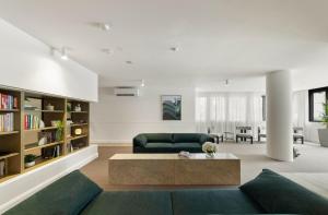 a living room with a couch and a coffee table at Chada by Cadiz Properties - 2 Bedroom Apartment with Lakeview Pool, within CBD and Beside Commonwealth Park in Canberra