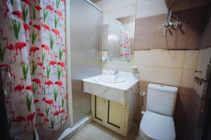 a bathroom with a toilet and a sink and a shower curtain at Star Luka in Luxor +45 photos
