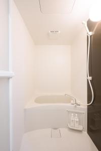a white bathroom with a shower and a sink at Kohoku Apartment in Tokyo +44 photos
