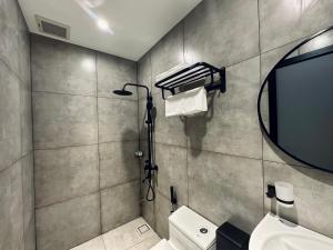 a bathroom with a sink and a mirror and a toilet at LION 12 Hotel in Can Tho