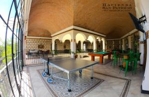 a room with a ping pong table in a library at Hacienda San Patricio in San Miguel de Allende