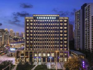 a rendering of a building in a city at night at Novotel Tianjin Drum Tower in Tianjin