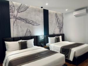 a hotel room with two beds and a mural at LION 12 Hotel in Can Tho