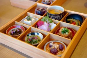 a box filled with different types of food and drinks at kānusuba zamami in Zamami