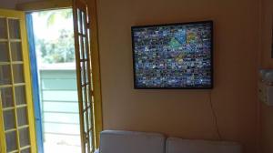 a television hanging on a wall in a living room at Cabana Jandaia in Teresópolis