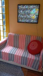 a couch in a room with a blanket on it at Cabana Jandaia in Teresópolis